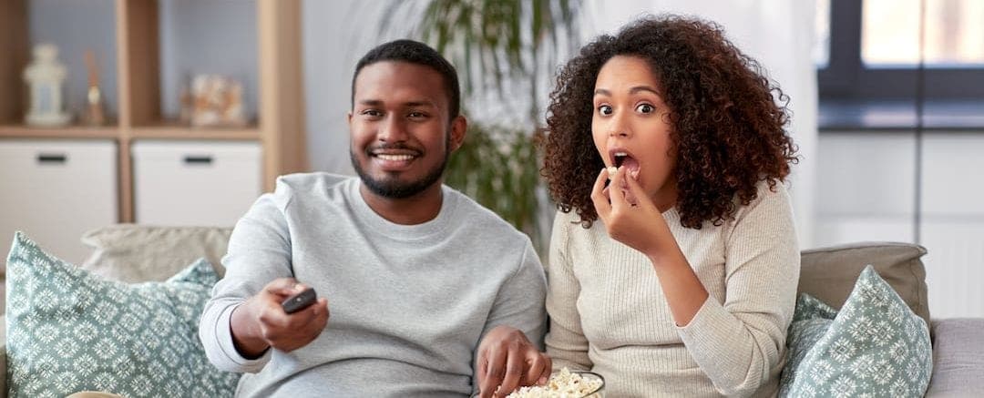 A black couple watching popular pop culture movies that get HVACs wrong.