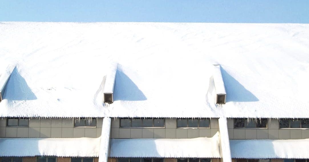 The winter weather of snow a facility's roof.