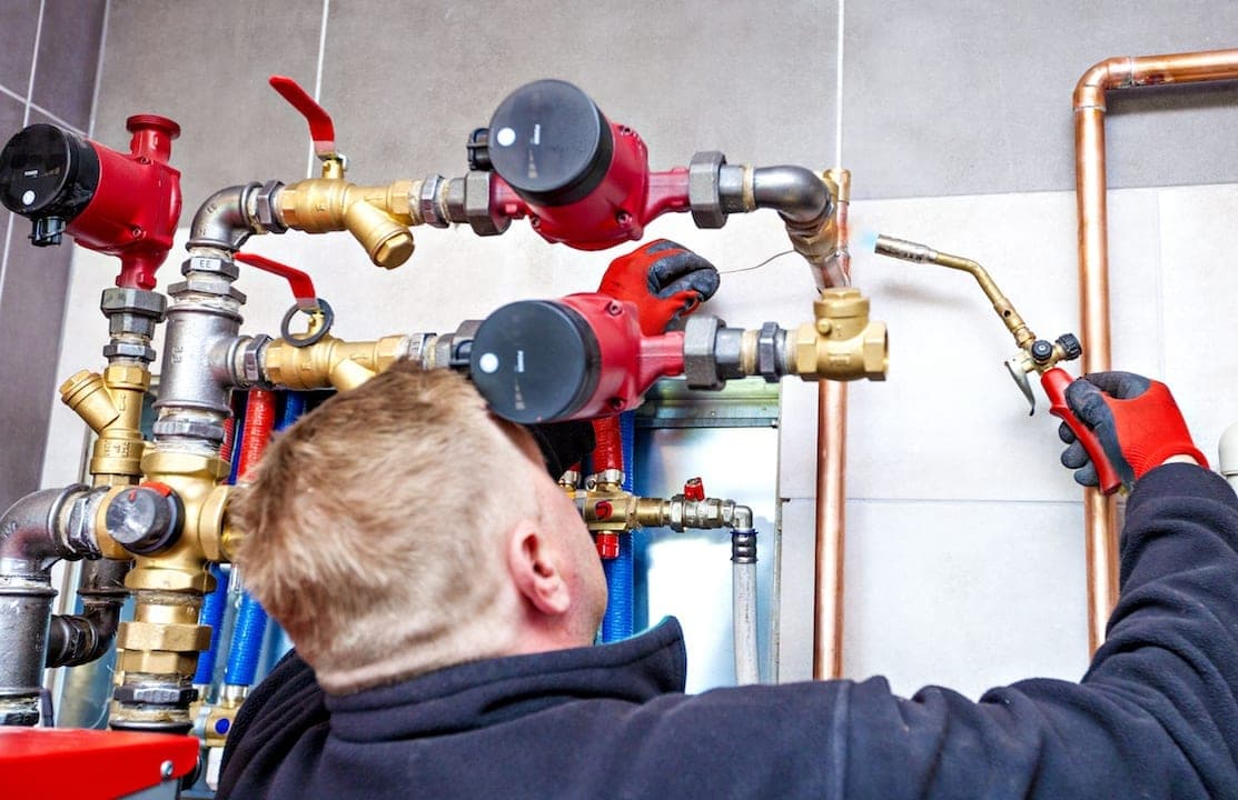 Technician fixing boiler system