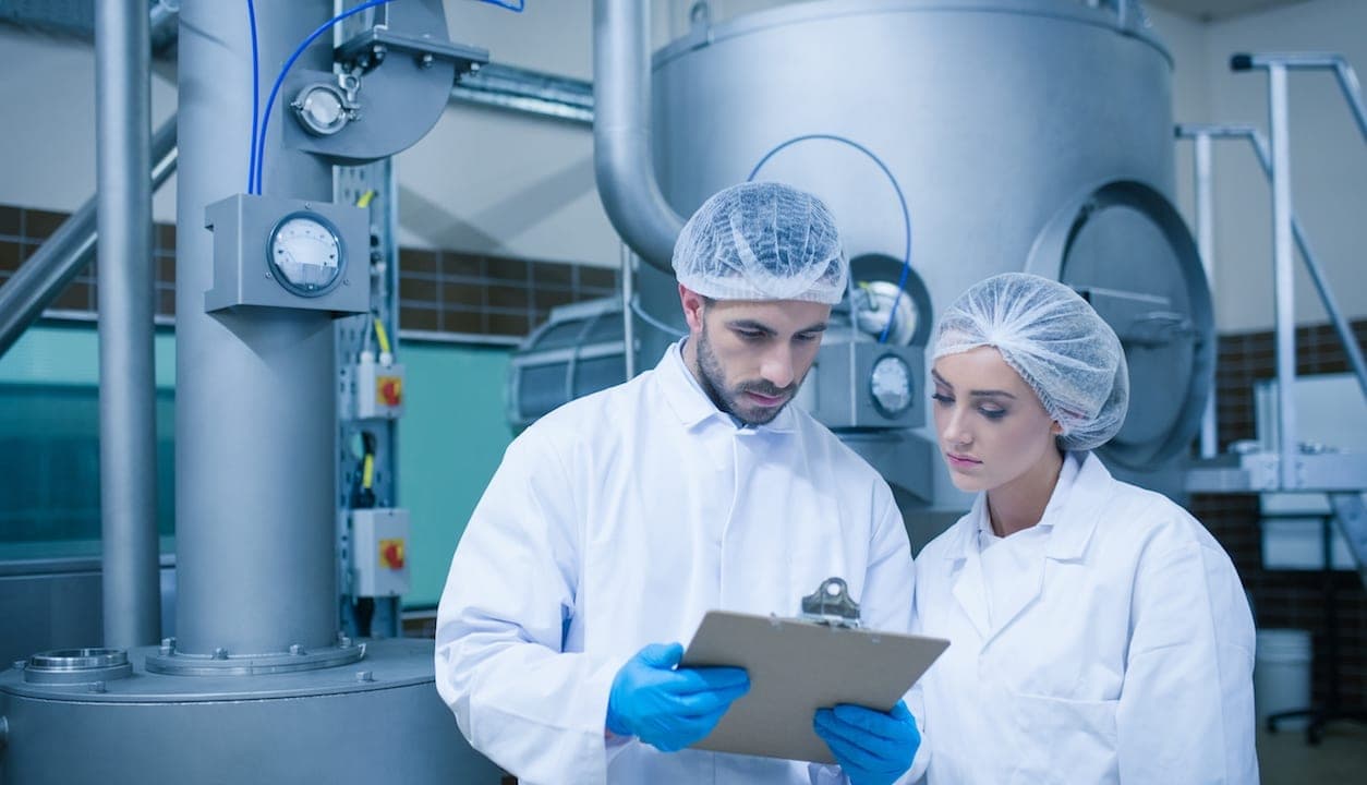 Food safety professionals looking over predictive maintenance strategy