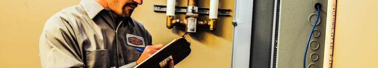 A RasMech technician surveying equipment.