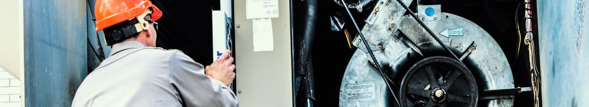 worker changes hvac filter