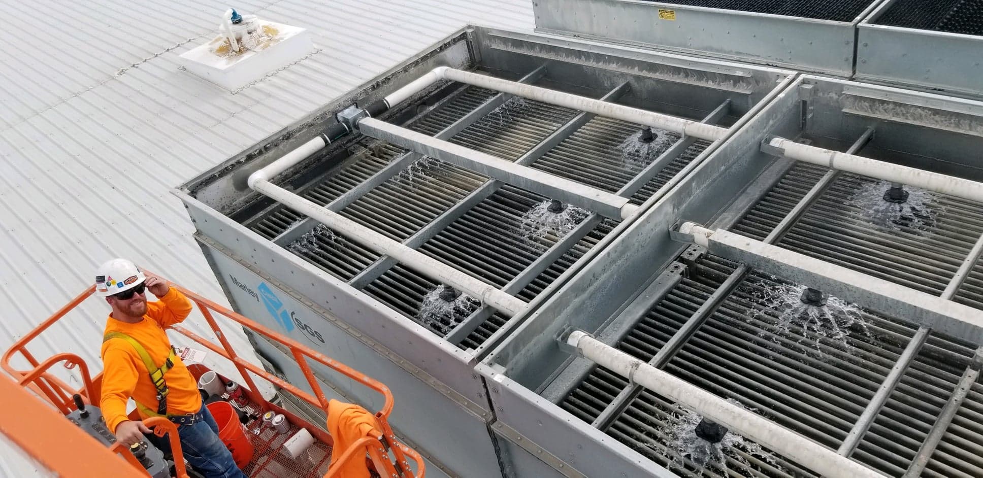 Rasmussen Mechanical Technician working on a cooling tower