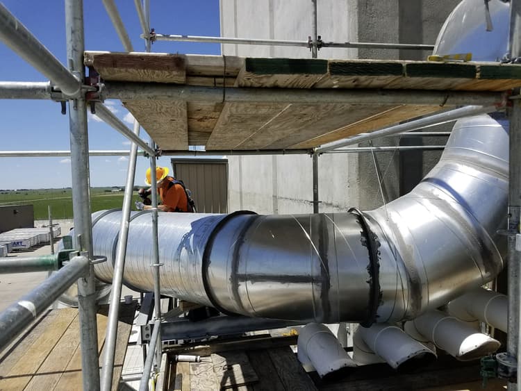 Installing HVAC outside of facility on scaffolding 3