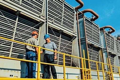 Cooling tower with Bruce Rasmussen and customer shaking hands