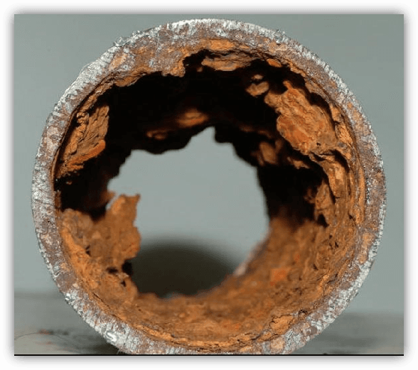 Corrosion caused by poor feed water on a steel pipe.