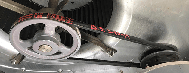 Close up of blower motor and belt assembly.