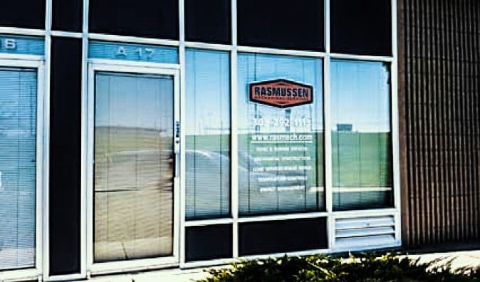 Store front view of featuring rasmussen mechanical services logo and contact information in white lettering