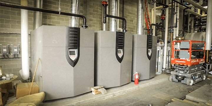 Three side by side Industrial Condensing Boiler Installed For A Facility.