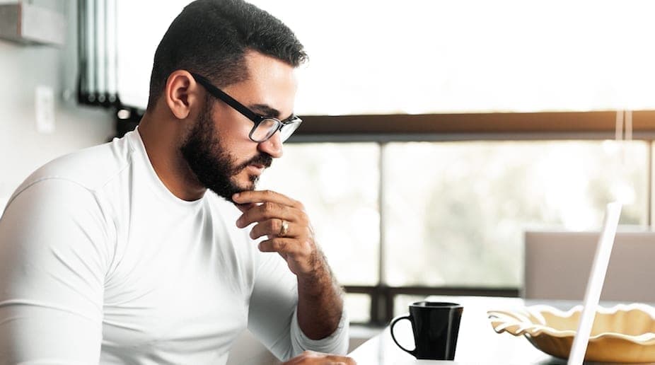 A HVAC technician looking at the new HVAC tax incentives.