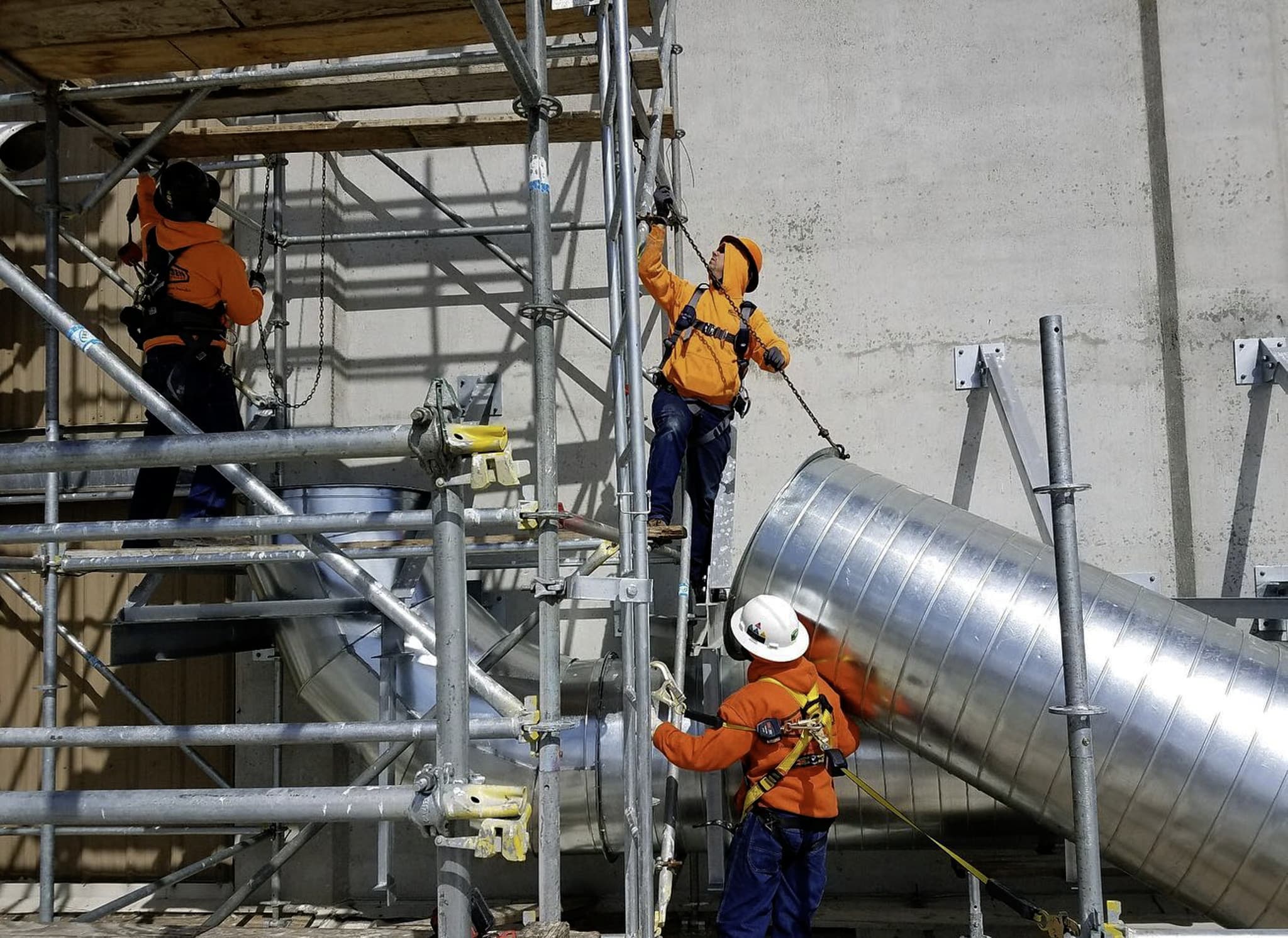 Rasmussen Mechanical Service Technicians Installing Commercial Ducting