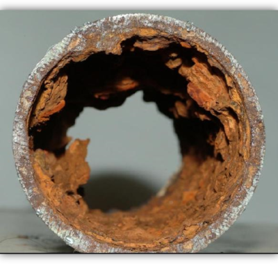 Corrosion caused by poor feed water on a steel pipe.