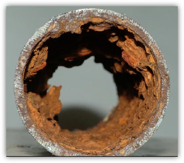 Corrosion caused by poor feed water on a steel pipe.