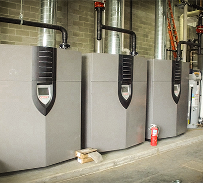 Three side by side Industrial Condensing Boiler Installed For A Facility.