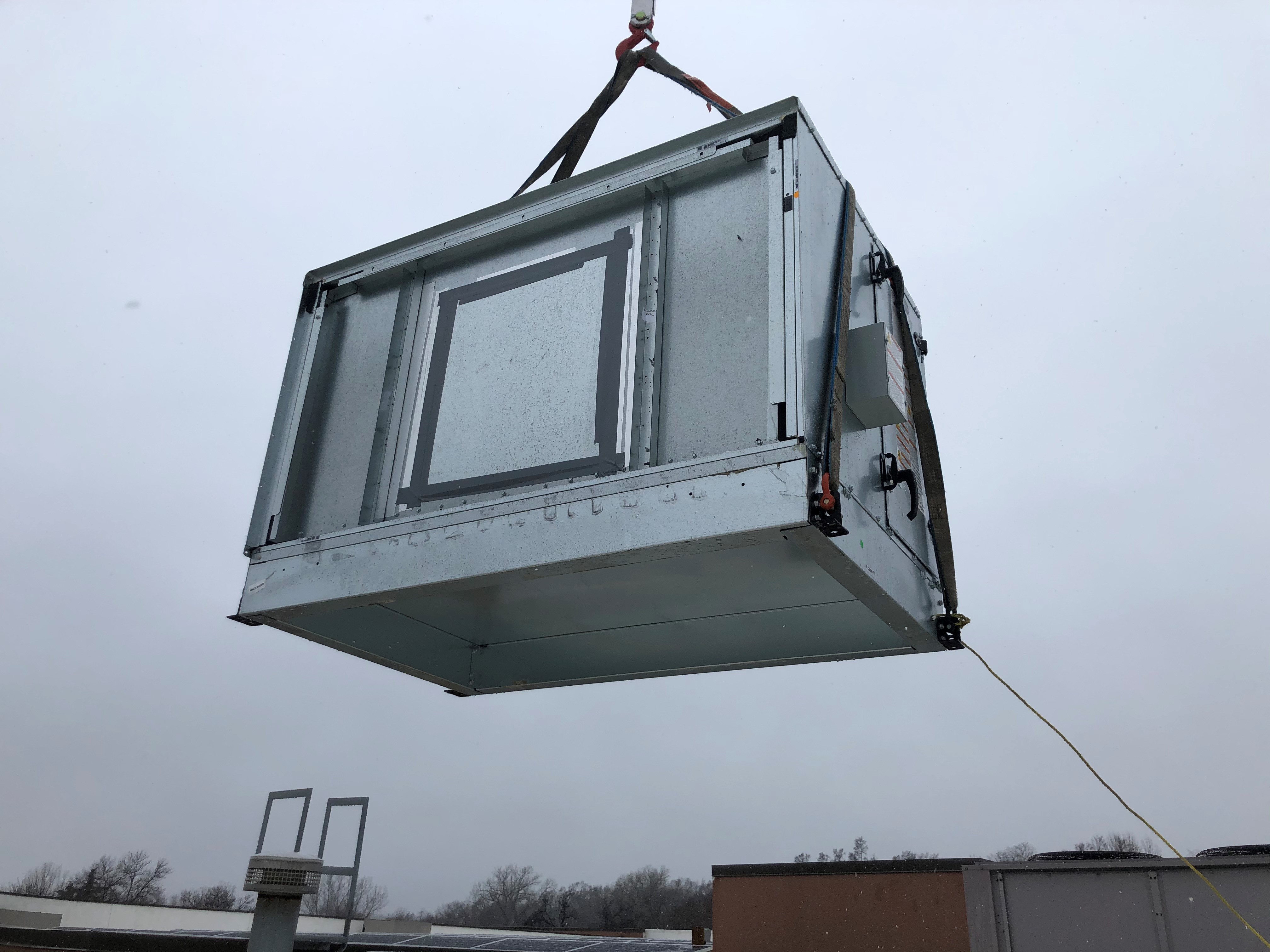 Close up of new AHU on crane 