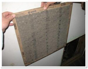 Common HVAC Problem: dirty filter taken out of a air conditioning unit.